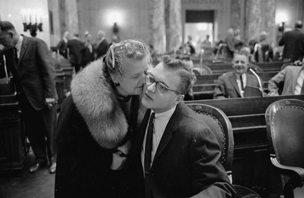 New Assemblyman Frederick P. Kessler, Democrat from Milwaukee, receiving a kiss on the check from his mother, Mrs. Frederick Kessler.  Kessler, the youngest lawmaker to serve in the state Legislature, recently turned 21 years old.