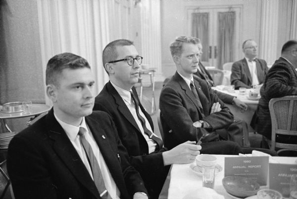 Three members of the Madison Chamber of Commerce listen to the guest speaker at the annual meeting. From left are: Robert L. Castleberg and Philip Stark, both of the Paul F. Stark Realty Company; and Gordon Findorff of J.H. Findorff and Son.