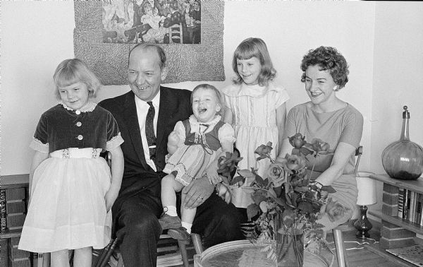 The Ivan A. Nestingen family poses with a congratulatory bouquet celebrating Mayor Nestingen's appointment as undersecretary of the United States Department of Health, Education, and Welfare. The family members with the mayor are, left to right: Leslie (6), Marcia (2), Laurel (8) and Geraldine, the mayor's wife.