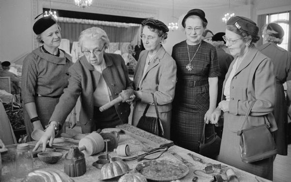 Kitchen utensils of another era were on display at the Women's Club of Madison hobbies and craft show. The collector, Florence Middleton, second from the left, points to an item while Leona Zimmerman, Helen Allen, Anne Sherburne, and Alma Beyer look on.