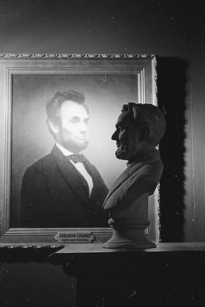 A bust and portrait of Abraham Lincoln. Photograph taken at an unknown location. 