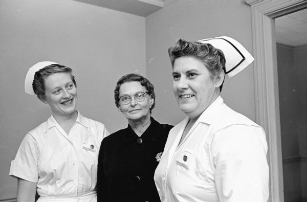 The annual meeting of the Women's Auxiliary at Madison General Hospital, 925 Mound Street, is held at the hospital. Three hospital staff members help coordinate the volunteers' work at the hospital. Shown, (L-R): are Betty Winkelman, supervisor of special services; Mrs. Kather Nelson, director of volunteers; and Anna Smith, director of nursing services.