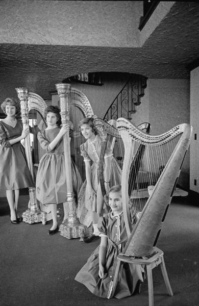 Four young harpists practice for the Madison Catholic Women's Club St. Patrick's Day program. Shown (L-R) are Renee Miller, Patricia Hippee, Diane Loeffler and Adrienne Loeffler. 