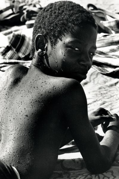 Close-up of a boy relaxing on a blanket on a hot day at B.B. Clarke Beach.