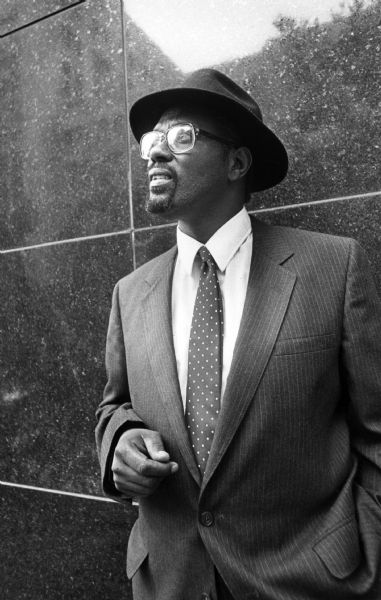 Activist Eugene Parks standing in front of a wall.