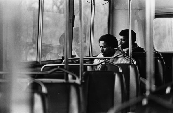 Two men riding the city bus.