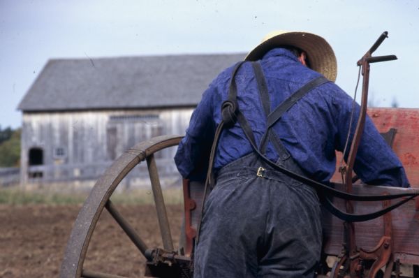 Farmer reaching into his wagon at Old World Wisconsin.