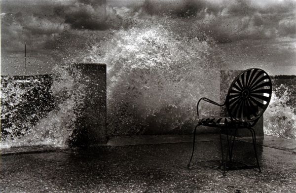 Waves from a stormy Lake Mendota crashing onto a chair at the Memorial Union Terrace.