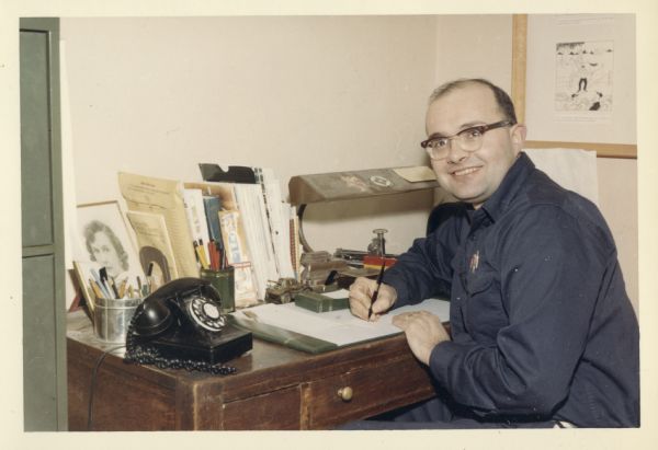 Gene Coffman, founder of Gratco Corporation, looking up from his office desk in his home, 414 Clemons Ave.