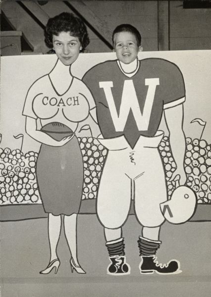 Carl Coffman and his mother, Evelyn B. Coffman, posing behind caricatures of a coach and a UW football player. Sid Boyum was the artist who painted the cutout for the portrait.