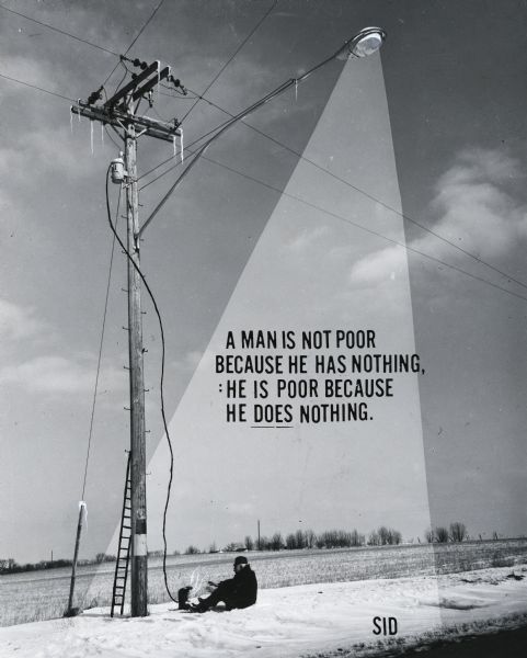 Outdoor view of Sid Boyum sitting in the snow and warming his hands with a heater, which is attached by a long power cord (hand-drawn) to a power line. Text printed on the image reads: "A man is not poor because he has nothing: he is poor because he does nothing."