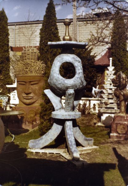 Sid's "Blue Tripod" among other sculptures in his backyard. The tripod measures 104" x 31" x 54". Madison-Kipp Corporation is in the background. 