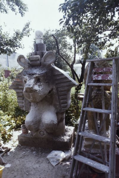 Sid's sculpture "Sphinx" in an early phase of construction in his backyard among trees and plants.