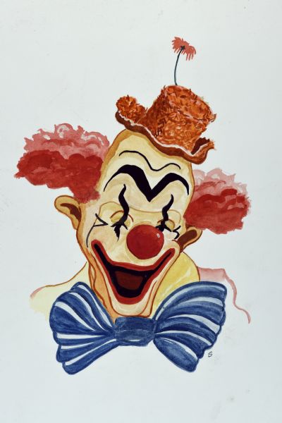 Head-and-shoulders portrait of a balding clown with a painted face and curly red hair. He is wearing a large blue bow tie and an orange hat with a flower on the top.