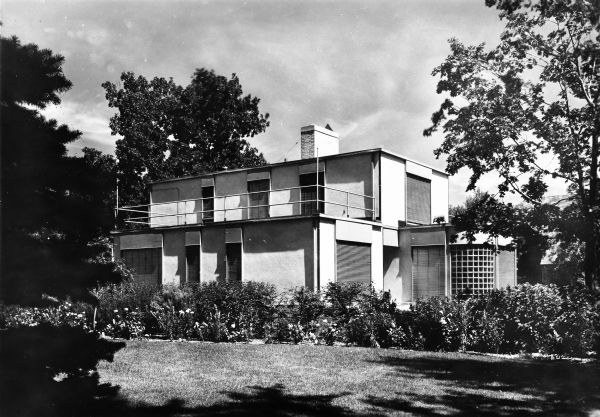 The Willard and Blanche Bellack House was designed by the architectural firm Keck and Keck as Project #221 in 1937. George Fred and William Keck were born in Watertown, Wisconsin, and operated an architectural office on Michigan Avenue in Chicago, Illinois. Willard Bellack was V.P. of Jersild Knitting Mills in Neenah, Wisconsin. This photograph shows Northeast facing perspective of the Bellack house on E. Forest Avenue, Neenah, Wisconsin. 