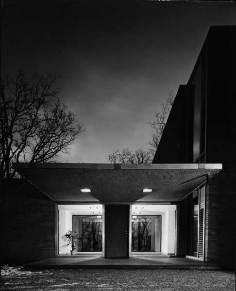 Edward McCormick and Elizabeth Blair House,Keck and Keck Project #500. Project date 1953. George Fred and William Keck were born in Watertown, Wisconsin, and operated an architectural office on Michigan Avenue in Chicago, Illinois. Edward Blair, a former managing partner of William Blair & Company in Chicago, also was the great-grandnephew of Cyrus McCormick, inventor of the McCormick reaper. Mr. Blair was a life trustee at the Art Institute of Chicago, the University of Chicago, Rush University Medical Center and College of the Atlantic, and a life director for the George M. Pullman Educational Foundation. This photograph shows the entry level between the two main nodes of the Blair house on N. Sheridan Road, Lake Bluff, Illinois.