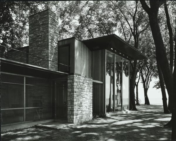 The William and Majel Kellett House was designed by the architectural firm Keck and Keck as Project #243 in 1940. This photograph shows the two-story, floor to ceiling windows outside living room of the Kellett house. Lake Winnebago is seen to the east of the house. William Kellett spent his entire professional life at Kimberly Clark Corporation, becoming it's President and eventually retiring in 1964. 