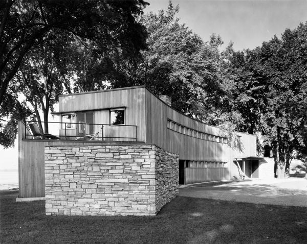 The William and Majel Kellett House was designed by the architectural firm Keck and Keck as Project #243 in 1940.   This photograph shows front of the Kellett house in Menasha, Wisconsin. The Fox river is seen to the west of the house. The back of the house faces Lake Winnebago to the south. William Kellett spent his entire professional life at Kimberly Clark Corporation, becoming it's President and eventually retiring in 1964.