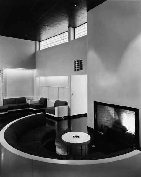 The Bertram and Irma Cahn House was designed by the architectural firm Keck and Keck as Project #213 in 1936. This is a photograph of the intimate ring of seating around the fireplace in the living room of the Cahn house on Green Bay Road in Lake Forest, Illinois. Bertram Cahn was President and Chairman of Kuppenheimer Clothing Manufacturers in Chicago. Irma Cahn, after seeing the House of Tomorrow at the Chicago World's Fair (Century of Progress), wanted to have George Fred design her a "House of the Day After Tomorrow."
