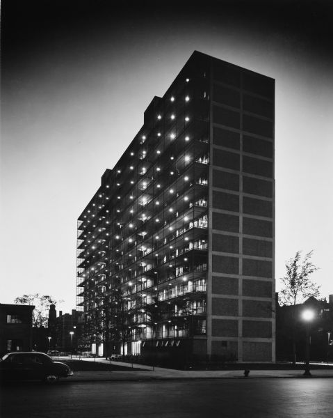 The Chicago Housing Authority's Prairie Avenue Court public house project was designed by the architectural firm Keck and Keck as Project #410 in 1950. The project included 2-story, 7-story, and 14 story housing units. This photograph of the 14-story building shows the south face of the structure. This project was designed with solar energy management principles in mind.  