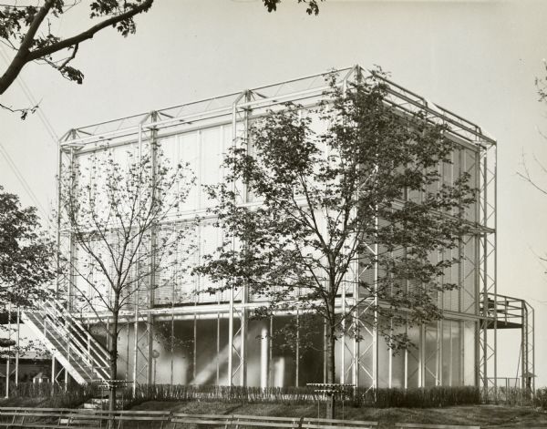 The Crystal House was Keck and Keck Project #183 in 1934. This project was done for the second year of the Chicago World's Fair, named "The Century of Progress." The Crystal House was built with glass walls suspended within an external structural steel cage. Fred Keck considered this building a candidate for prefabricated construction and estimated that the house could be built for $3,500 each if production runs would exceed 10,000 units. This is an exterior photograph of the Crystal house situated on Lake Michigan.