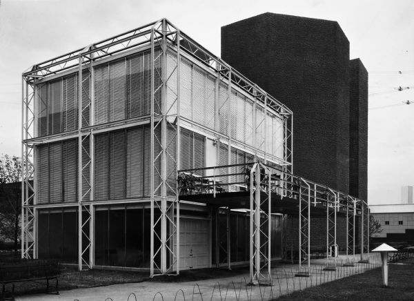 The Crystal House was Keck and Keck Project #183 in 1934. This project was done for the second year of the Chicago World's Fair, named "The Century of Progress." The Crystal House was built with glass walls suspended within an external structural steel cage. Fred Keck considered this building a candidate for prefabricated construction and estimated that the house could be built for $3,500 each if production runs would exceed 10,000 units. This exterior photograph of the Crystal house shows the patio on the second level's east facing side of the house.