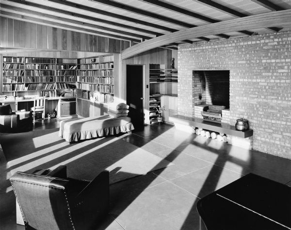 The Hugh and Minna Duncan house was designed by the architectural firm Keck and Keck as Project #268 in 1941. The Duncan house was a Keck "Solar House" and was studied by the Illinois Institute of Technology to measure its energy efficiency. This is a photograph of the living room in the DeCoster House in Flossmoor, Illinois. Hugh Duncan was a Sociologist at the University of Chicago.