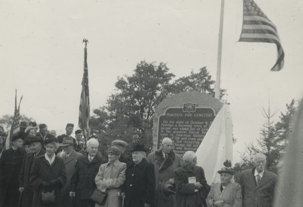A group of survivors of the Peshtigo Fire of 1871 are gathered in front of the Peshtigo Fire historical marker. The marker dedication coincided with the 80th anniversary of the fire.