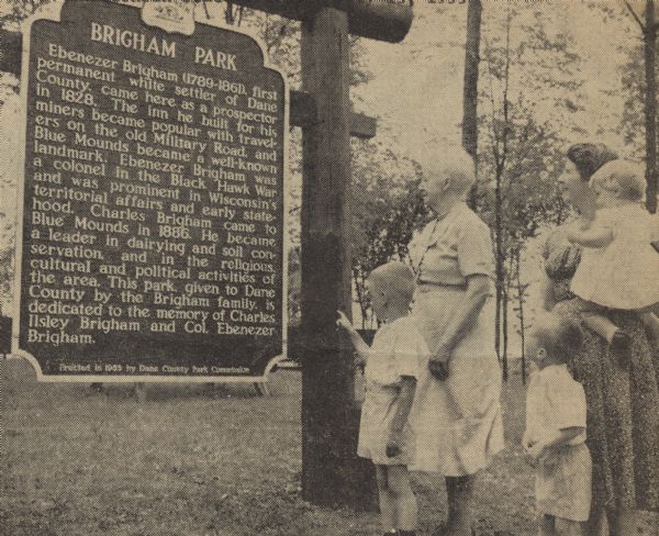 Mrs. Charles I. Brigham (left), and her daughter-in-law, Mrs. Charles Brigham, Jr., with her children Mark, Jonathan, and Elizabeth, standing and reading the historical marker dedicated to family member Charles Brigham, a leader in agriculture, and to Colonel Ebenezer Brigham, a colonel in the Black Hawk War and instrumental in territorial and early statehood affairs.  