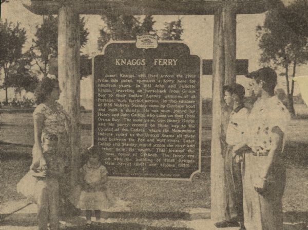 Fourth, fifth, and sixth generations of the Knaggs family gathered by the Knaggs Ferry historical marker to honor their family member. Mrs. Walter Dugolenski, and her children, Thomas and Ellen, are standing to the left of the marker, and standing on the right are Charles, Clifford, and Neil Knaggs. Charles unveiled the historical marker to the public during the ceremony. 