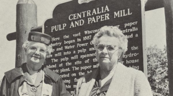 Mrs. Vida Calkins and Mrs. Caroline Mott, descendants of the founders of the Centralia Mill, standing in front of the historical marker honoring the work of their ancestors.  Mrs. Calkins is the granddaughter of contractor-millwright Charles D. Lemley who built the mill and Mrs. Mott is the daughter of Frank Garrison, one of the founders of the mill. 