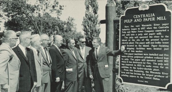 Participants in the dedication ceremony for the Centralia Pulp and Paper Mill historical marker included, from left to right: Wisconsin Rapids Mayor Nels Juteson, Dr. Leland Pomainville, president of the South Wood County Historical Society, Neil Nash, vice-president and secretary of Nekoosa-Edwards Paper Company, Dr. Rogers Garrison, grandson of one of the founders of the mill, Senator John Potter, Assemblyman Harvey Gee, William Schereck, field director for the Wisconsin State Historical Society, and J. Marshall Buehler, master of ceremonies for the dedication program. 