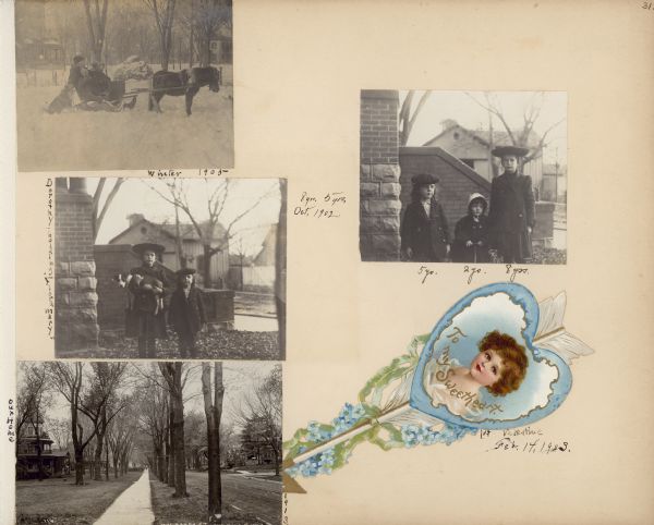 An album page featuring a die cut, chromolithograph Valentine's Day card in the shape of an arrow. The greeting "To My Sweetheart" is printed on the card, and a handwritten caption describes it as "1st Valentine Feb, 14, 1904." Three photographs and a postcard are also mounted on the page. In the photograph at top left, the three Fargo children, Dorothy, Frank and Stuart are sitting in a sleigh hitched to a pony. Dorothy is wearing a fur stole. The family dog is sitting beside the sleigh. Snow is falling and there is fairly deep snow on the ground. The front porch of their house (the Frank B. Fargo residence) is at left; a house across Mulberry street is in the background, right. In the photograph at middle left, taken in October 1902, Dorothy Fargo is holding a dog as she is posing with her brother Stuart near the steps of their house. A carriage house is in the background. In the photograph at top right, taken the same day, Stuart, Frank and Dorothy are standing together near the porch. At bottom left, a commercial real photo postcard captioned "Mulberry St. Lake Mills, Wis." includes the Frank B. fargo house at left. Tall trees are along the sidewalk.
