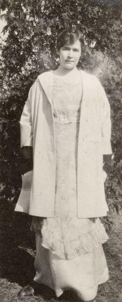 Twenty-year-old Dorothy Fargo posing outdoors for a full-length portrait. She is wearing a light-colored dress with a long jacket. A handwritten caption reads: "Ready for Recital Mt. Carroll Ill." Dorothy was the daughter of Frank B. and Louise Mears Fargo of Lake Mills, Wisconsin.
