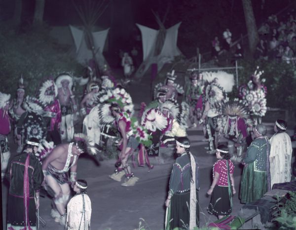 A group of Native American Indians, dressed in ceremonial clothing, perform the War Dance at the Stand Rock Indian Ceremonial.