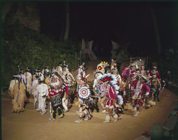 Elevated view of a group of men and women performing ceremonial dances at the Stand Rock Indian Ceremonial. 
