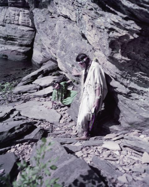 Two young women, Annette Miner and Carolyn Young, are climbing on rocks at Soomis's beard.
