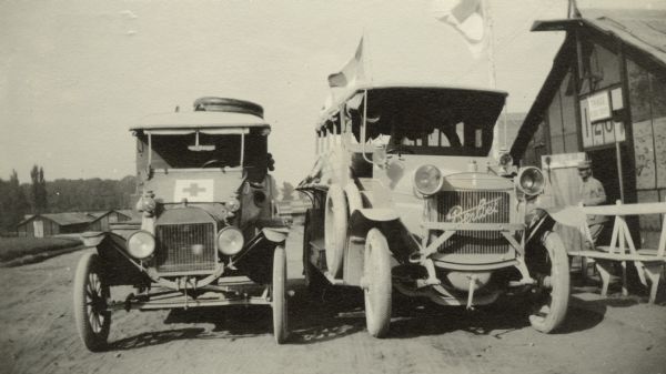 Two ambulances parked near a building. Captioned: "My ambulance contrasted with a French one."