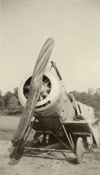 Wingless airplane sitting outdoors. Captioned: "A Nieuport at a repair depot."