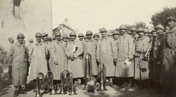 Group of band members posing for a commemorative group portrait. Captioned: "The band of the 50th Chasseures at Bowancount."