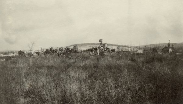 View across field of the remains of a Moscow Brewery and Sugar Refinery. Captioned: "Moscow — Hill 108, with ruins of sugar refinery and brewery. Boche trenches are on this side of the hill and Moscow is not a healthy place to inhabit."