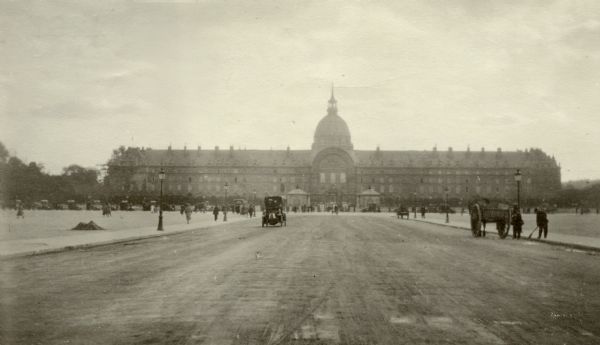 View down street and plaza towards buildings in Paris. Captioned: "The Pantheon; Napoleon's Tomb; the Invalides."