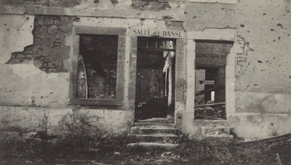 Exterior view of the damage to the dance hall in Cormicy. Caption reads: "The Cormicy dance-hall. Dance halls in France, whether wrecked as this one or not are just as desolate, for a law prevents dancing in France during the war."