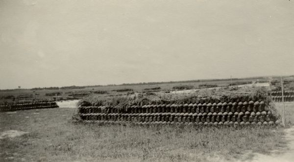 View across field towards a well-camouflaged military weapon.