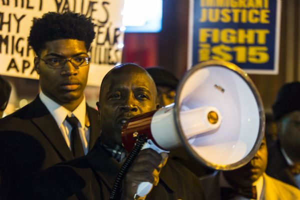 Close-up view of Joe Davis, Milwaukee's 2nd district Alderman, as he is speaking through a megaphone to a crowd of protesters outside the Republican presidential debate.