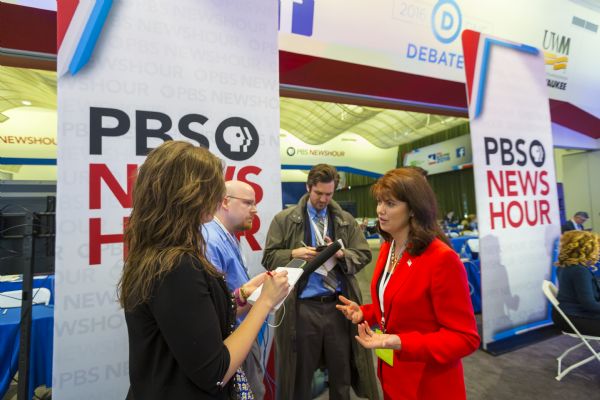 Three journalists interviewing Lieutenant Governor Rebecca Kleefisch in the spin room of the Democratic presidential debates.