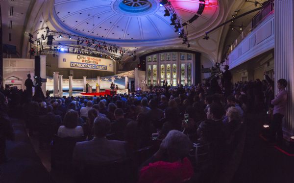 View from the back of the audience of the Democratic presidential debate, held at the Helen Bader Concert Hall in the Helene Zelazo Center for Performing Arts on the University of Wisconsin-Milwaukee campus. Bernie Sanders and Hillary Clinton are standing on the stage behind podiums.