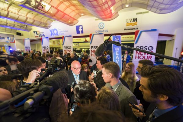 Elevated view over crowd of people towards Jeff Weaver, a spokesperson for Democratic presidential candidate Bernie Sanders, talking to reporters in the spin room after the Democratic presidential debate.