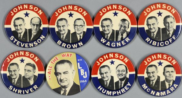 An assortment of political campaign buttons for Lyndon B. Johnson. Seven out of eight buttons have a white background with red and blue borders, and black and white head and shoulder portraits of Lyndon B. Johnson and supporters with a blue star above their heads. They include Abraham A. Ribicoff; Hubert H. Humphrey, Jr.; Robert S. McNamara; Coke R. Stevenson; Sargent Shriver; and George Brown. The last button includes a head and shoulders portrait of Lyndon B. Johnson in front of a gold and blue background and reads: "..All the Way," "with LBJ 1964."