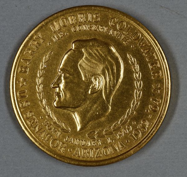 Coin depicting Barry Goldwater's head in profile surrounded by a laurel wreath, and the words: "Barry Morris Goldwater, Mr. Conservative, Born January 1, 1909, U.S. Senator, Arizona, 1952-'64."